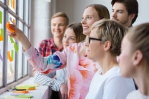 Happy office team meeting with sticky notes